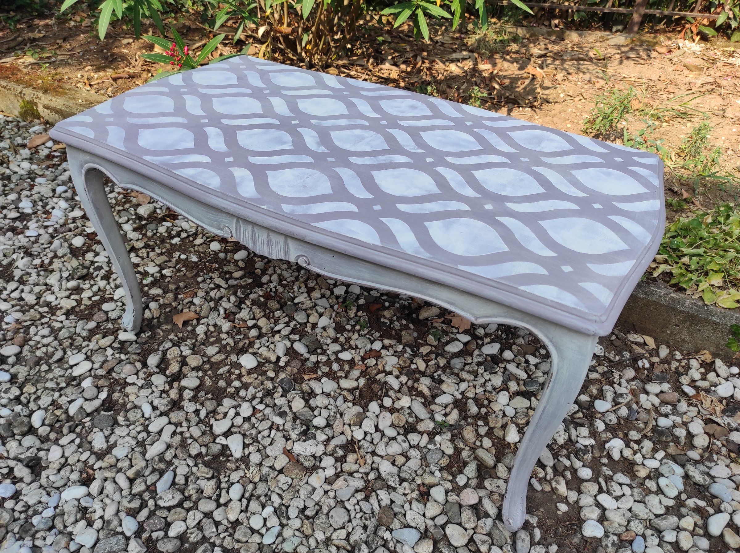 Tavolino con gambe a sciabola dopo il restyling: piano grigio-lilla con decoro bianco a stencil, struttura grigio chiaro anticata